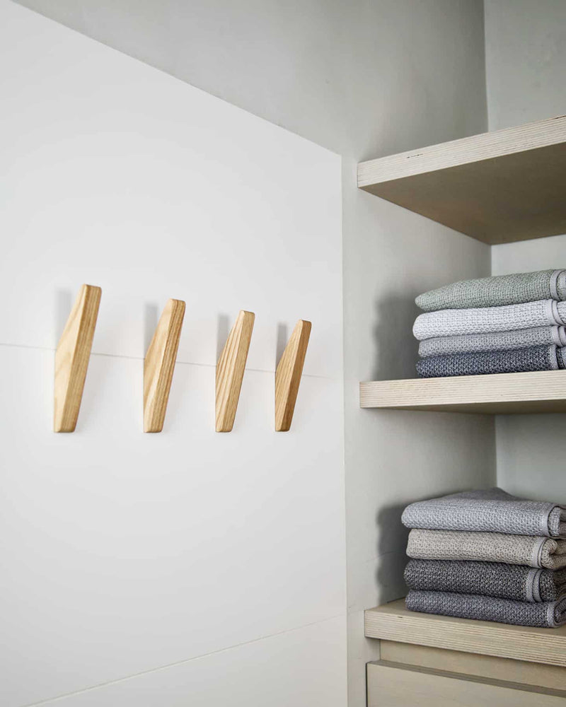 Four natural oiled Oak Wood Wall Hooks in bathroom.