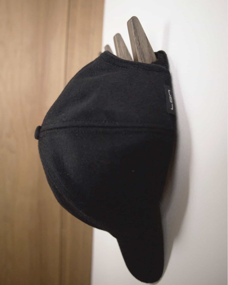 Black wool cashmere cap on black oiled Oak Wood Wall Hooks.